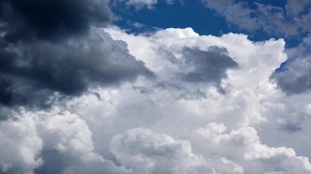 Timelapse of Storm Clouds with Dark Foreground and White Cumulus Against Blue Sky