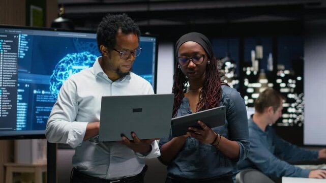Tech agency colleagues collaborating to optimize AI performance in office late at night with debugging and troubleshooting context.