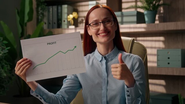 Happy Caucasian business woman presenting finance chart documents thumb up in office workplace smiling businesswoman female boss showing profit income growth graph results trading investment report