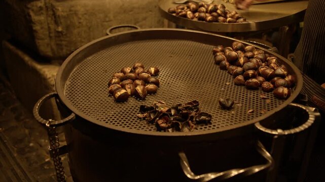 Close View of Roasted Chestnuts Cooking in Market Pan Rome Italy Traditional Street Food Shot with Cinema Camera