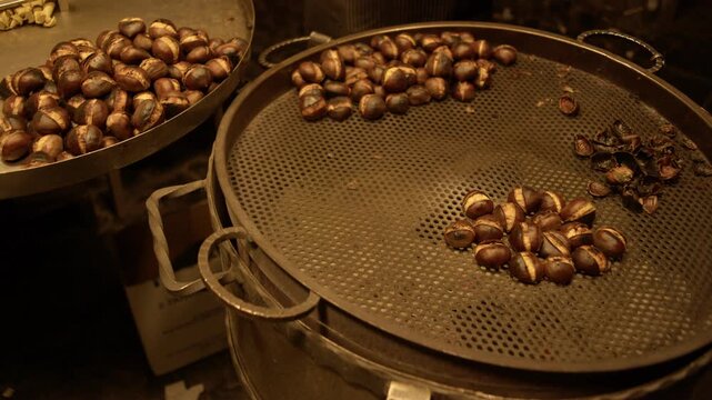 Roasted Chestnuts Cooking in Traditional Street Food Stall Rome Italy Night Market Scene Shot with Cinema Camera
