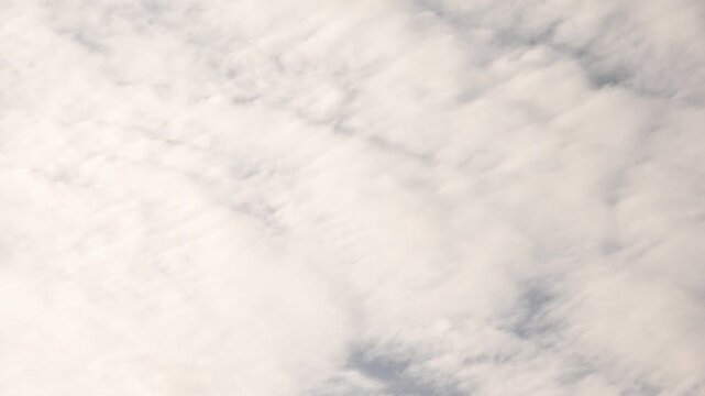 Soft white clouds covering a bright sky
