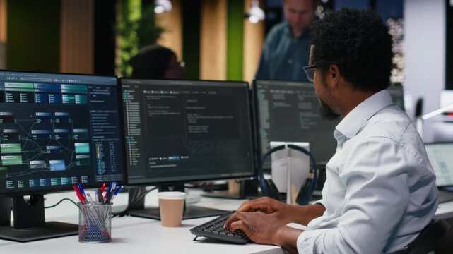 Engineer in Silicon Valley company office developing apps with AI. IT professional using machine learning to do coding, debugging applications to resolve issues for coding workflows.