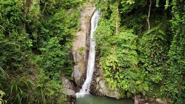 Push-in aerial fly close shot of Pamuayan Falls in Port Barton, Philippines