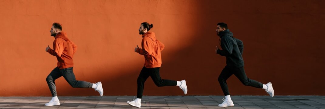 Three runners wearing orange hoodie jogging along an orange wall for fitness background banner and urban training poster design