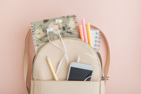  Organizing a feminine pink backpack with school supplies