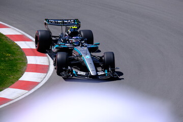 Obraz premium May 24, 2026, Montreal, Canada, Mercedes F1 car racing through Circuit Gilles Villeneuve corner. g.