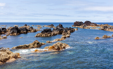 Fototapeta premium Mosteiros Natural Pools in Sao Miguel, Azores. Volcanic rock formations in the Atlantic Ocean. Clear blue waters and rugged coastline of Portugal.
