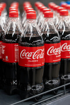 Coca Cola soda bottles in refrigerator on shelves at supermarket, ready for retail sale. Minsk, Belarus - March 31, 2025