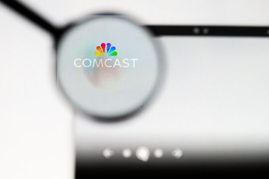 Milan, Italy 2026, 20 Apr Closeup of Comcast website on a laptop screen. Comcast logo under a magnifying glass.
