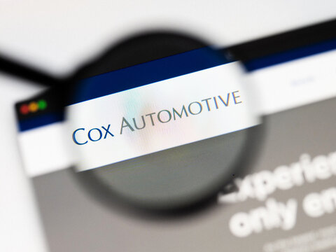 Milan, Italy 2026, 20 Apr Closeup of Cox automotive website on a laptop screen. Cox automotive logo under a magnifying glass.