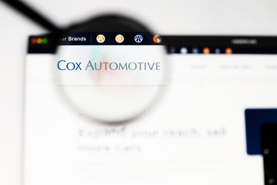 Milan, Italy 2026, 20 Apr Closeup of Cox automotive website on a laptop screen. Cox automotive logo under a magnifying glass.