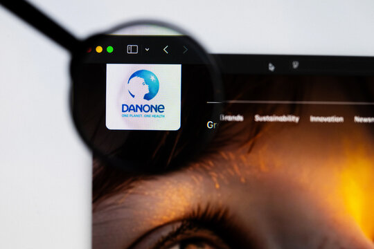 Milan, Italy 2026, 20 Apr Closeup of Danone website on a laptop screen. Danone logo under a magnifying glass.