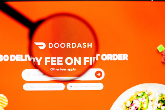 Milan, Italy 2026, 20 Apr Closeup of Doordash website on a laptop screen. Doordash logo under a magnifying glass.
