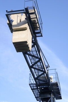 Construction crane jib arm with ballast weight against sky