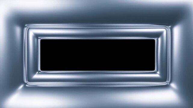 Slow zoom tracking shot of metallic rectangular frame tightening and smoothing inward through studio interior close up revealing reflective silver surface motion