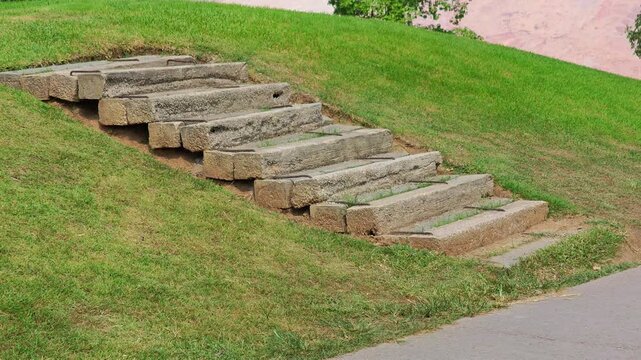 The stairs are made of concrete slabs , on the golf course