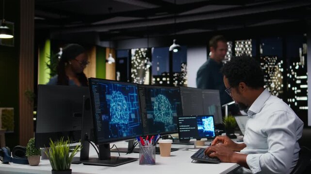 Tech startup IT professional developing AI algorithms in high rise office during late night shift. man debugging neural network brain models on screens for software development use.