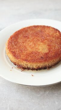 traditional Turkish kunefe dessert with melting cheese and pistachio on a plate