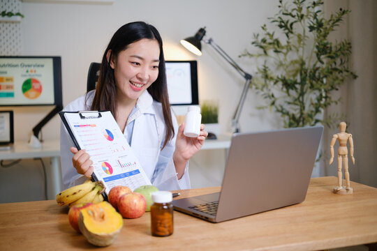 Nutritionist presenting a supplement bottle during an online health consultation, representing diet planning and wellness advice.