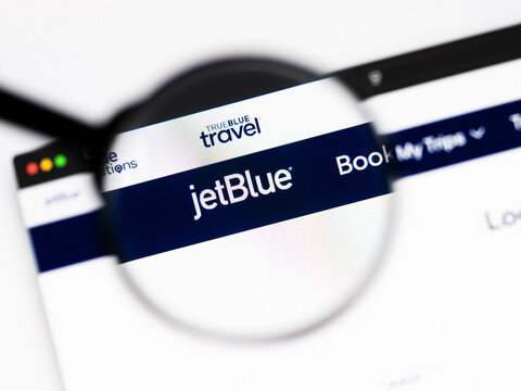 Milan, Italy 2026, 20 Apr Closeup of jetblue website on a laptop screen. jetblue logo under a magnifying glass.