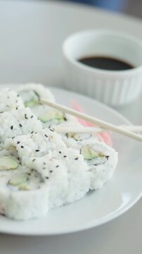 Asian, food and sushi on table with chopsticks, culinary and seafood cuisine at restaurant. Traditional, meal and Japanese catering with soy sauce, fine dining and hospitality for authentic delicacy
