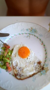 Homemade breakfast plate with fried egg and avocado