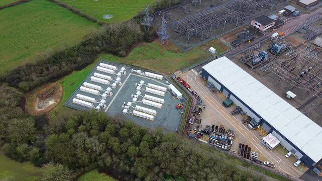 Birds eye perspective of industrial electrical infrastructure and containerized lithium battery pack array England