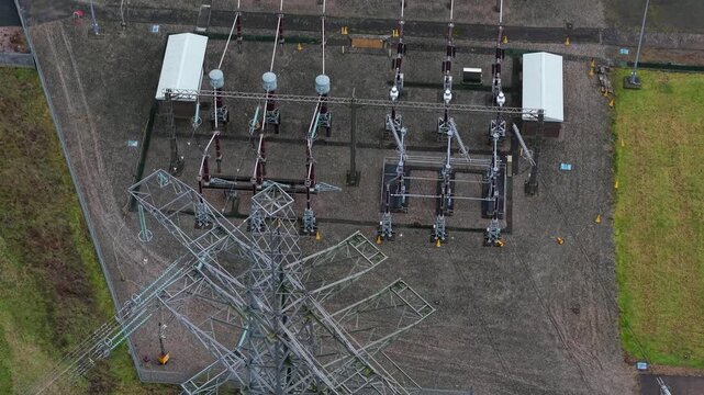 High angle aerial drone view of a high voltage electrical substation and busbar power lines in Enderby United Kingdom