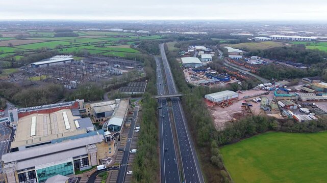 Overhead aerial shot looking down at industrial distribution centers and corporate logistics estates in England