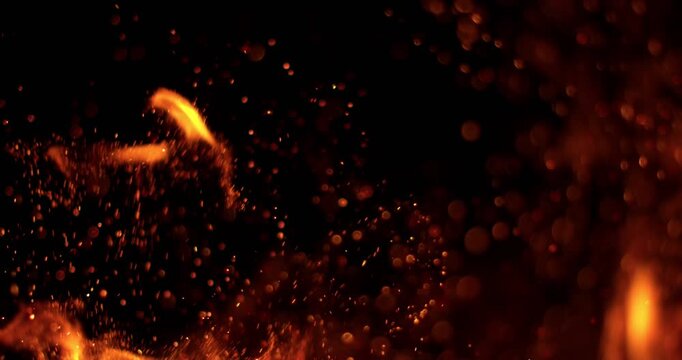 Ultra slow motion floating embers and glowing sparks on black background captured at 1000 FPS. Atmospheric fire particles drifting through darkness, ideal for cinematic overlays.