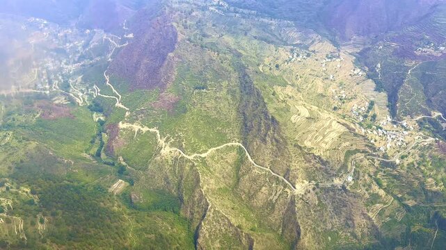 Aerial view of mountain village with terraced hillside for farming in Utara Khand