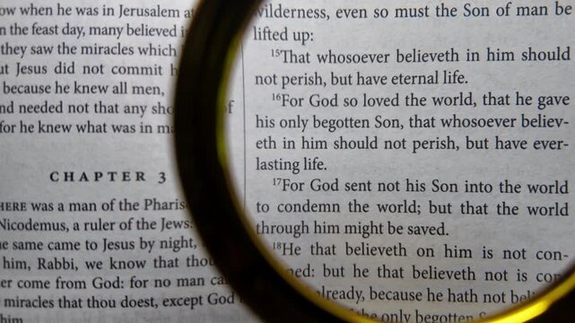 Magnifying glass over john 3 16 bible verse close up scripture for god so loved the world christian faith