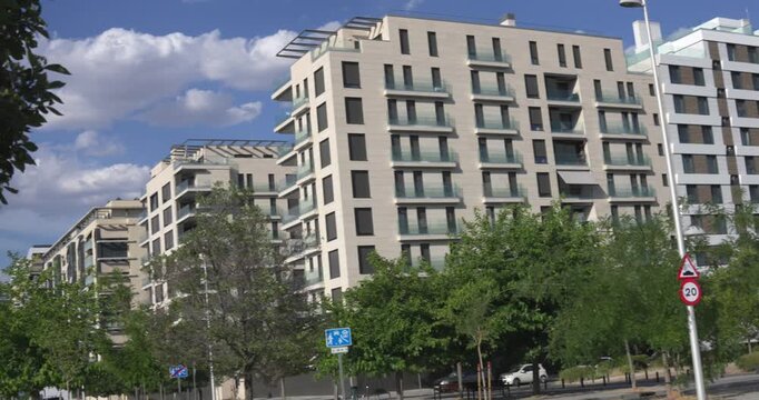 Modern residential buildings with trees and cloudy sky