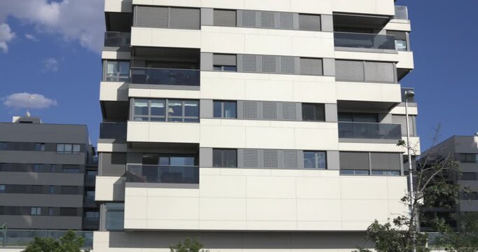 Modern apartment buildings with balconies and clouds
