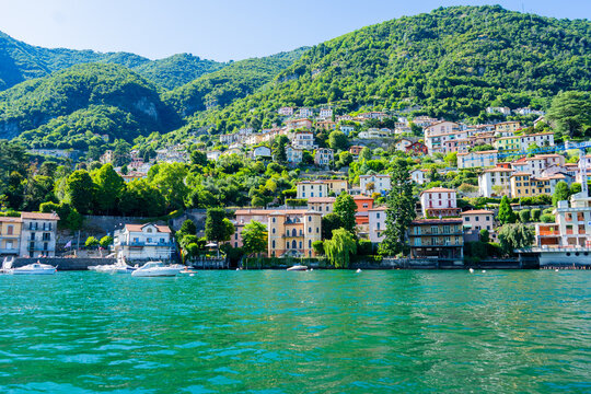 Nature Lake Como Italy Lago di Como Alps Mountains. Green picturesque Hills town Bellagio and Varenna. Italian travel. Blue summer sky. Water boat.
