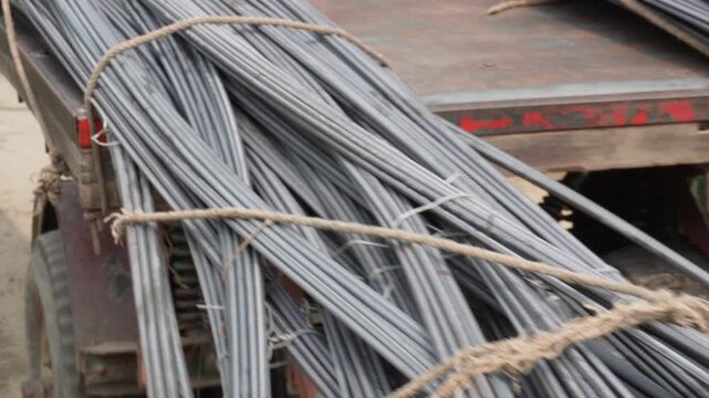 Steel rebar bundles transported on flatbed trailer