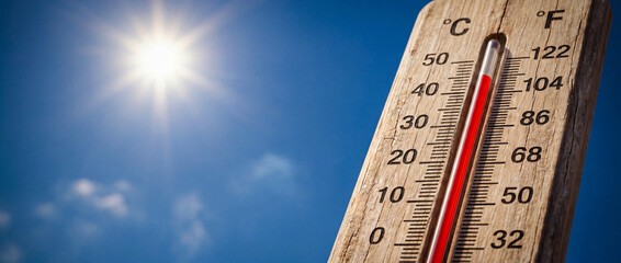 Summer heat wave, high temperature on outdoor thermometer under scorching sun. Hot weather, global warming