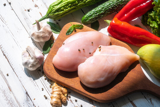Freshly prepared ingredients for cooking: chicken breast and vegetables