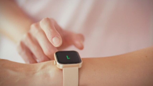 In home gym, girl stares at her smartwatch screen as countdown timer ticks down, signaling upcoming workout. Her focused eyes track each second, embodying fitness motivation and sleek wearable tech