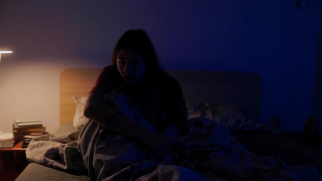Scared child throwing blanket off waking up in panic from severe night terror