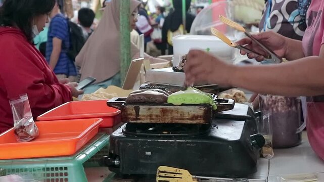 Street food vendor cooking traditional indonesian pukis cake