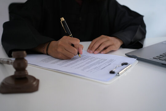 Lawyers or advocates signing consent documents, concepts of justice, corporations, justice and rights, insurance, courts and authorities. World Justice Day
