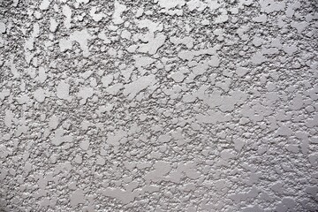 Obraz premium Rough-textured concrete or stucco wall with vertical streaks.