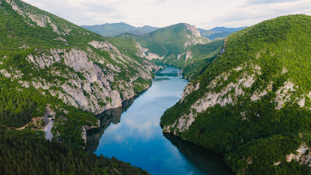 Drone panorama of calm waters winding through a spectacular mountain canyon landscape