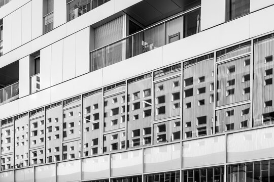 Monochrome apartment buildings in Paris show a dense residential facade, where windows, balconies and urban architecture form a graphic exterior grid