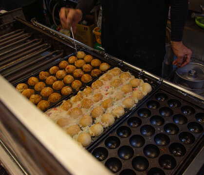 Takoyaki Cooking on Hot Griddle at Japanese Street Food Stall