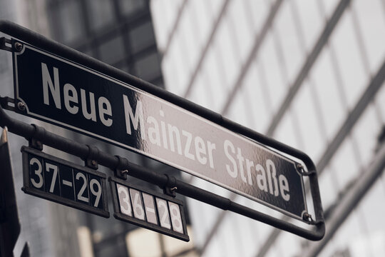 Neue Mainzer Stra&szlig;e sign in Frankfurt Bankenviertel, Germany, sits against glass office buildings, where street detail and urban architecture locate the financial district