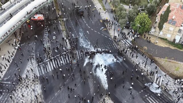 Aerial view Ultra Orthodox Protest Against Military Draft Jerusalem

Drone footage of ultra Orthodox protest near Chords Bridge, Cannon Dispersing Draft Protest Jerusalem, Israel, 1 June 2026.

