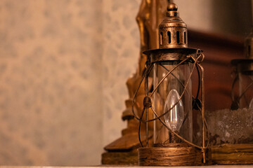 Vintage Decorative Lantern with Warm Light on Wooden Interior Background, Cozy Rustic Decor with Copy Space © Валентина Руденька